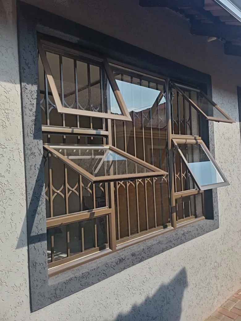 Bronze aluminium windows with matching retractable burglar proofing fitted behind the glass